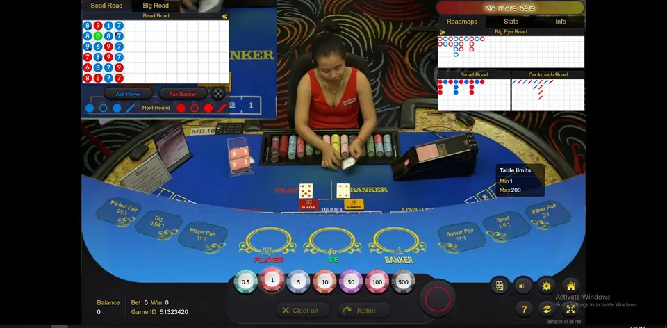 Dealer sliding a card from the shoe with the chip rack in front and Table limits Min 1 Max 200